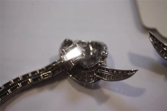 A nice pair of platinum and diamond encrusted scrolling and double drop earrings, 6.5cm.